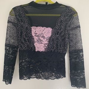 Exude femininity in this lovely lace top by GUESS
